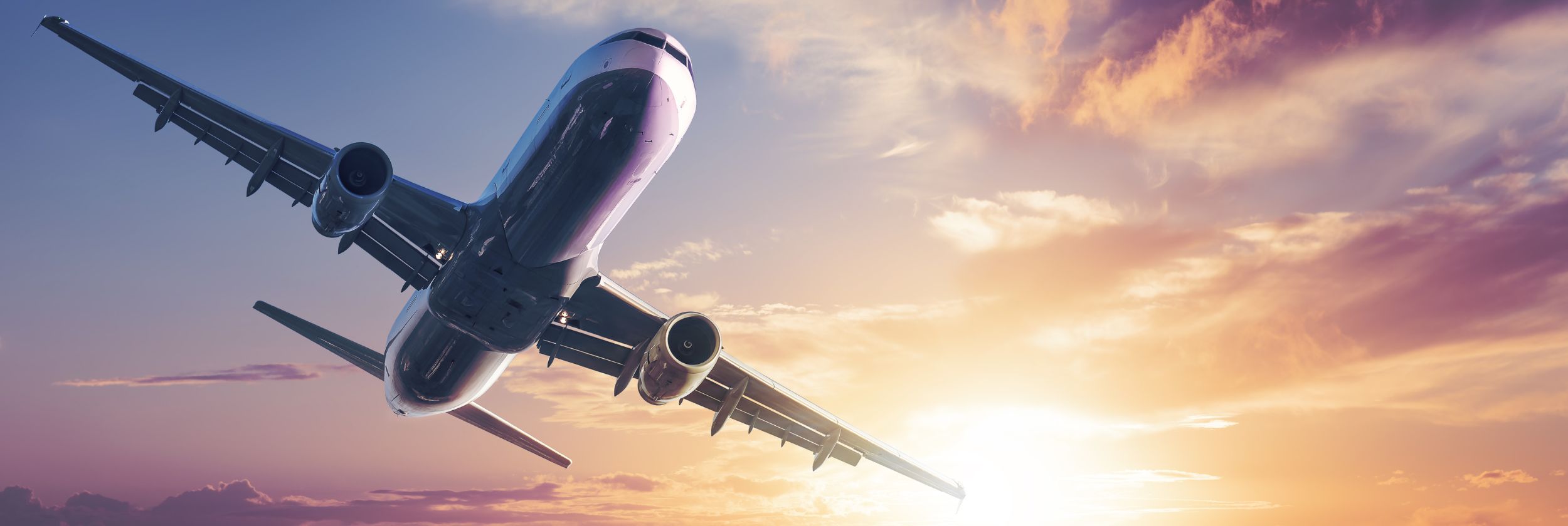 airplane flying into sunset