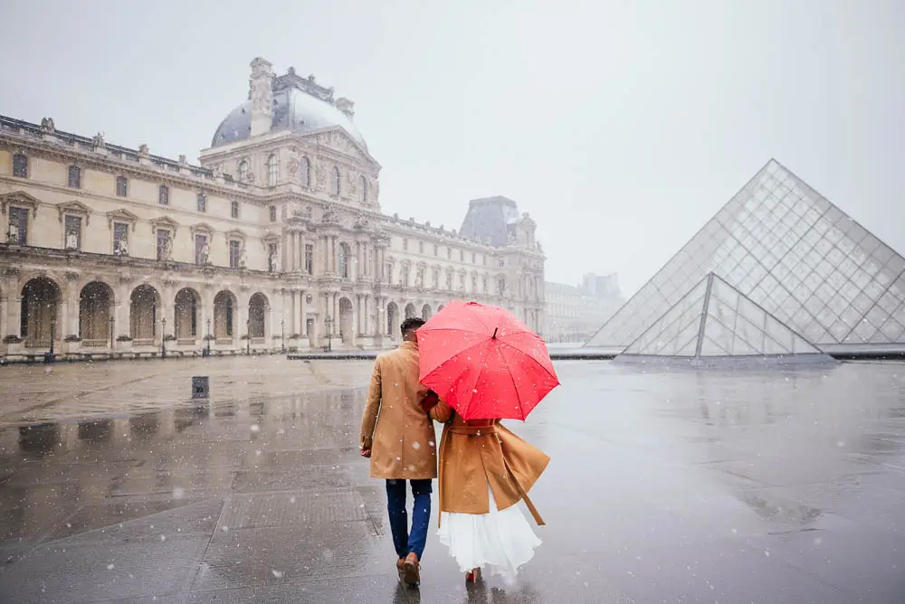 Man and woman with an umbrella at the Louvre