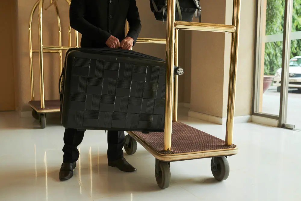 A bellhop picking up luggage